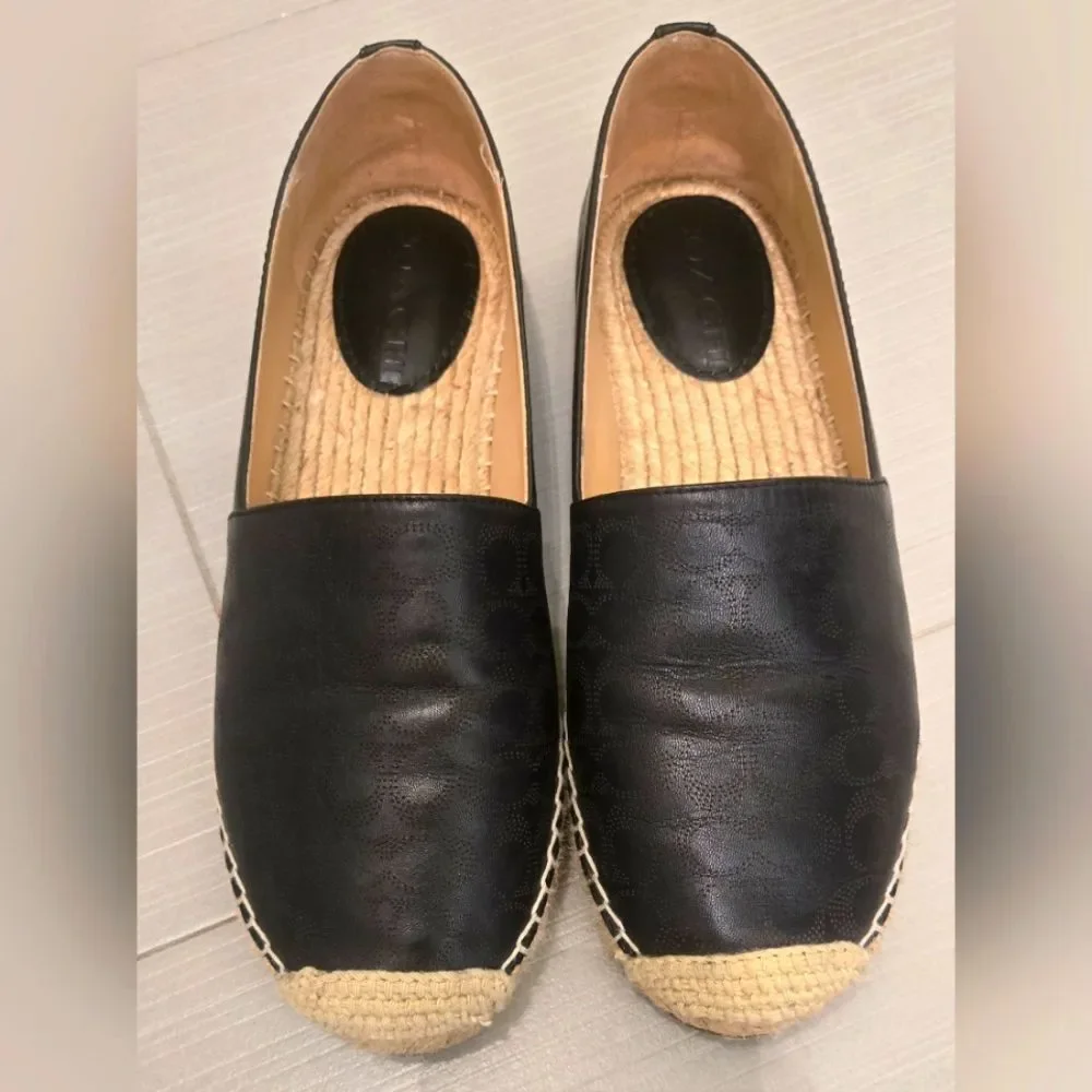 Coach Carley Black leather Espadrille Slip-On Shoes with Coach design on top.